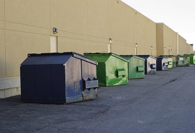 a row of construction dumpsters parked on a jobsite in Coral Springs, FL